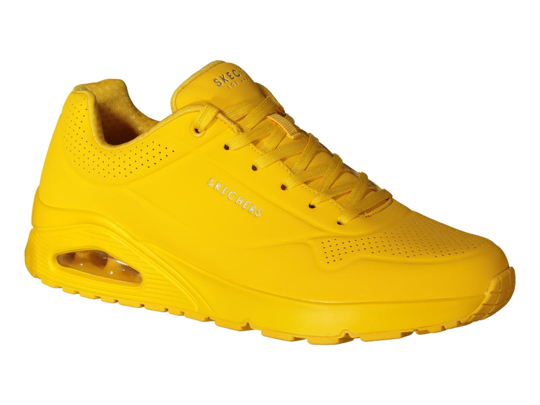 Tenis deportivos Skechers color amarillo brillante con suela amortiguada y detalles perforados.