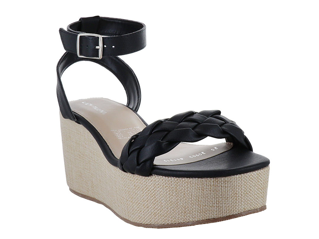 Sandalia negra para mujer con tira trenzada, plataforma beige y correa ajustable al tobillo.