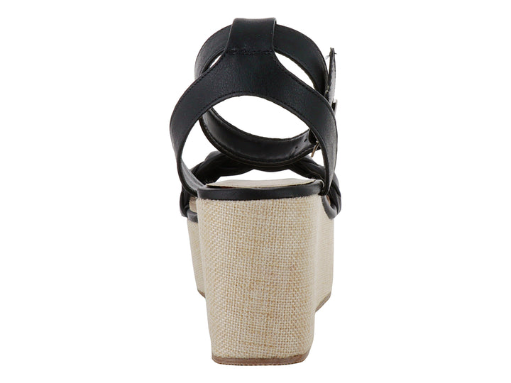 Sandalia negra para mujer con tira trenzada, plataforma beige y correa ajustable al tobillo.