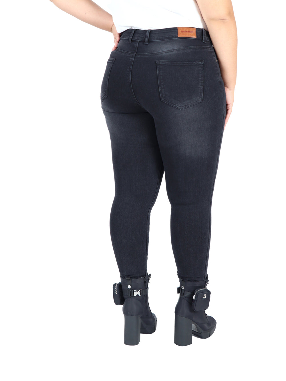 Pantalón jeans ajustado color negro para mujer con detalles rotos en las rodillas.