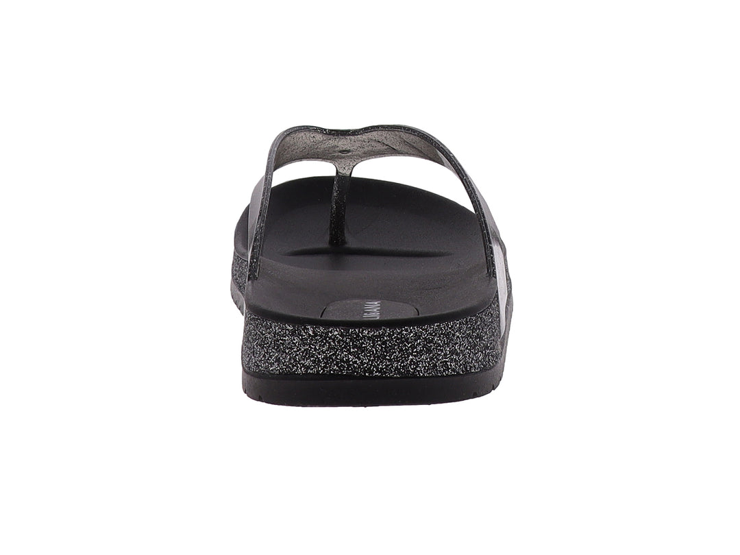 Sandalias negras para mujer con correa transparente y suela con detalles brillantes.
