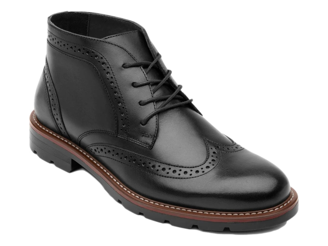Bota negra de cuero con detalles perforados tipo brogue y suela track.
