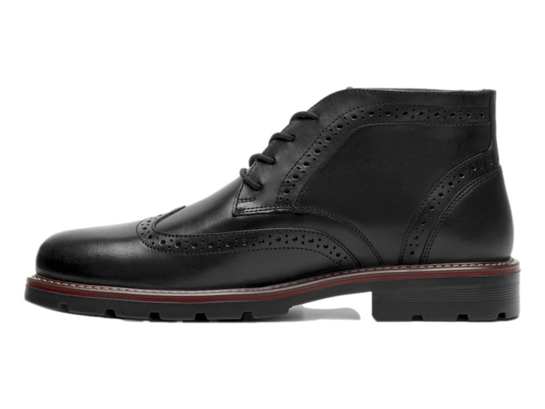 Bota negra de cuero con detalles perforados tipo brogue y suela track.