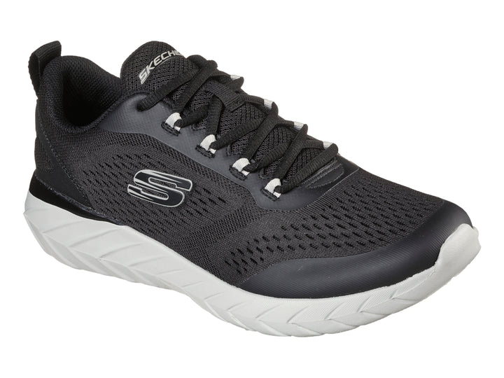 Tenis deportivos Skechers color negro con suela blanca y tejido de malla transpirable.