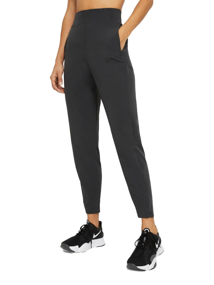 Pantalones deportivos Nike Dri-FIT Bliss en color gris oscuro para mujer.