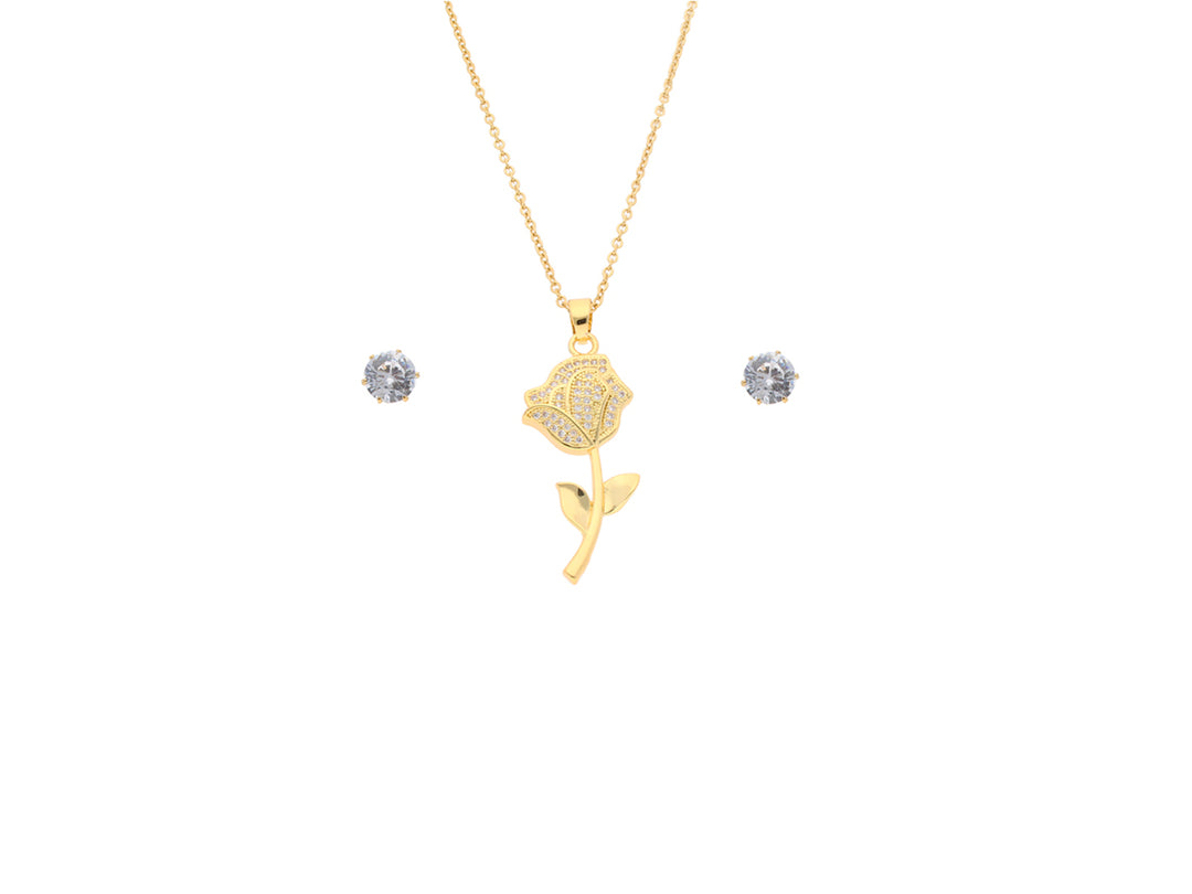 Set de joyería color oro con collar de dije en forma de rosa y aretes brillantes.
