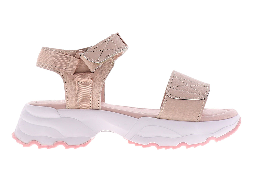Sandalia infantil color beige con suela blanca de plataforma y correa de ajuste con velcro.
