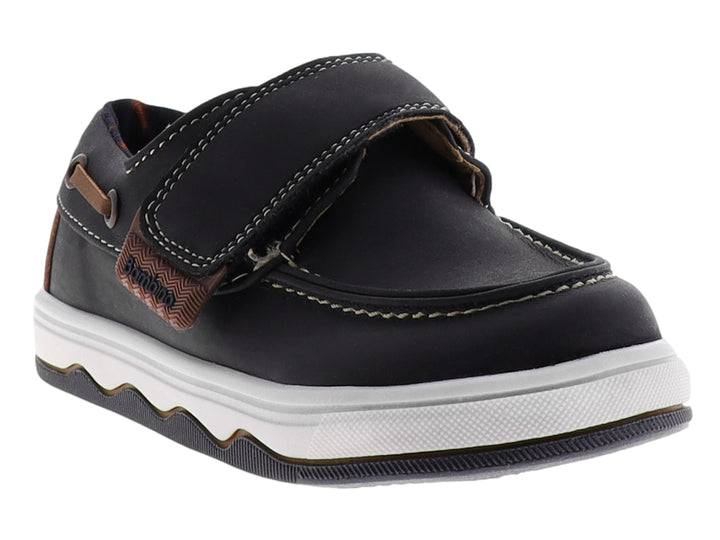 Zapato infantil tipo mocasín color navy con suela blanca y detalle de correa marrón.