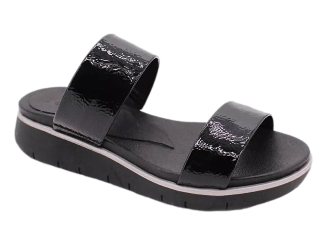Sandalias negras de charol brillante con plataforma y dos bandas anchas sobre fondo blanco.