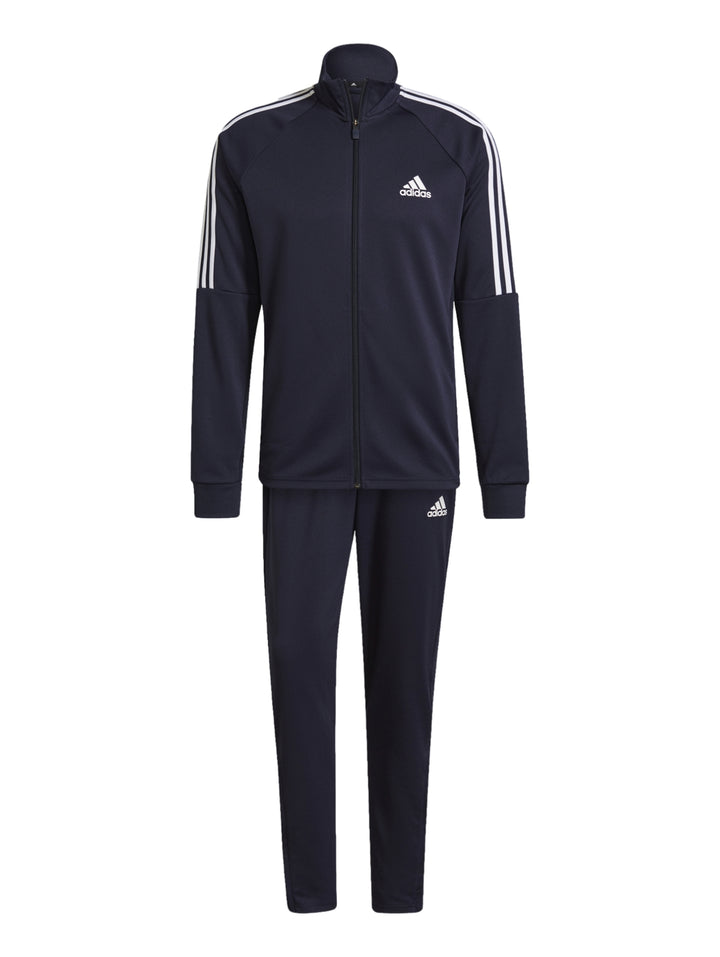 Hombre vistiendo conjunto deportivo Adidas color azul marino con rayas blancas laterales.