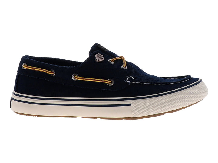 Zapato náutico Sperry color azul marino con suela blanca y cordones marrones.