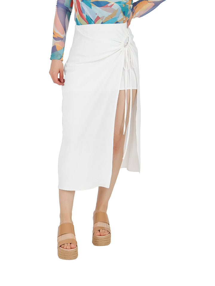 Mujer vistiendo falda larga color ivory con diseño envolvente y detalle de amarre lateral.