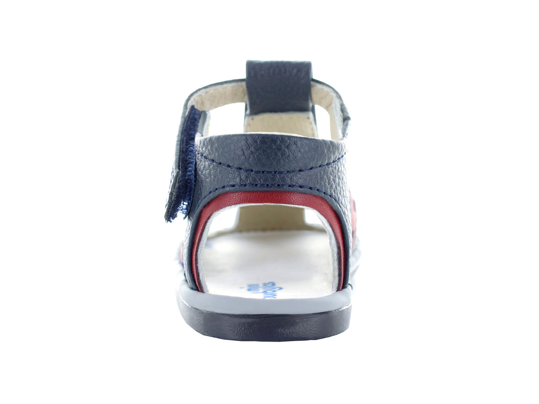 Sandalias infantiles color azul marino con tiras en gris y rojo.