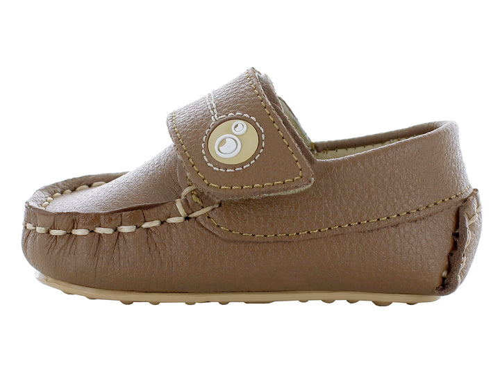 Par de mocasines color camel para bebé con correa de ajuste y costuras decorativas en color beige.