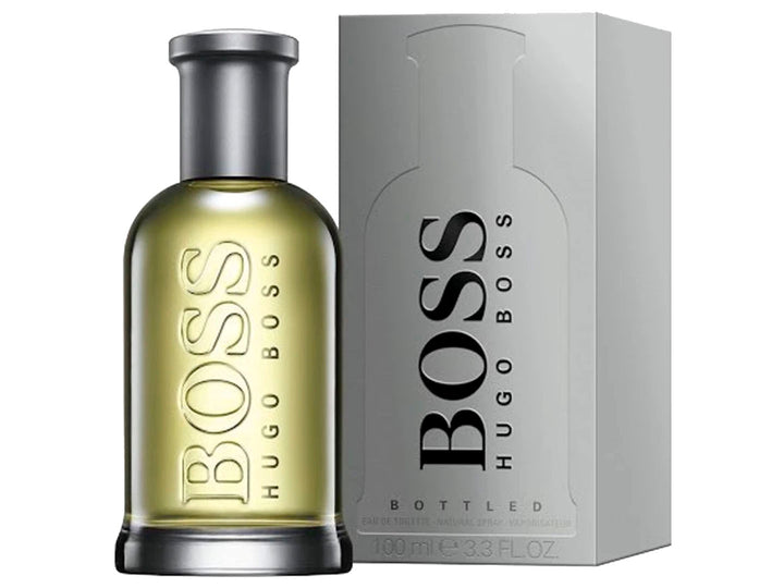 Perfume Hugo Boss Bottled en frasco de vidrio con líquido amarillo y su caja gris plateada.