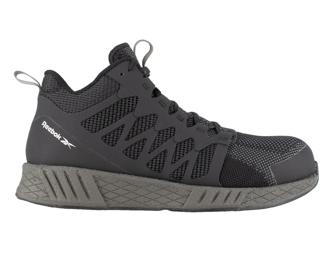 Tenis de seguridad Reebok en color negro con puntera y suela en gris oscuro.