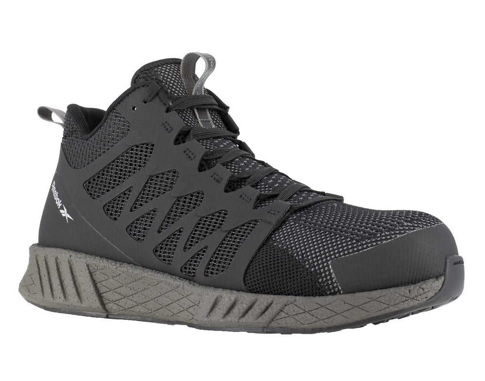 Tenis de seguridad Reebok en color negro con puntera y suela en gris oscuro.
