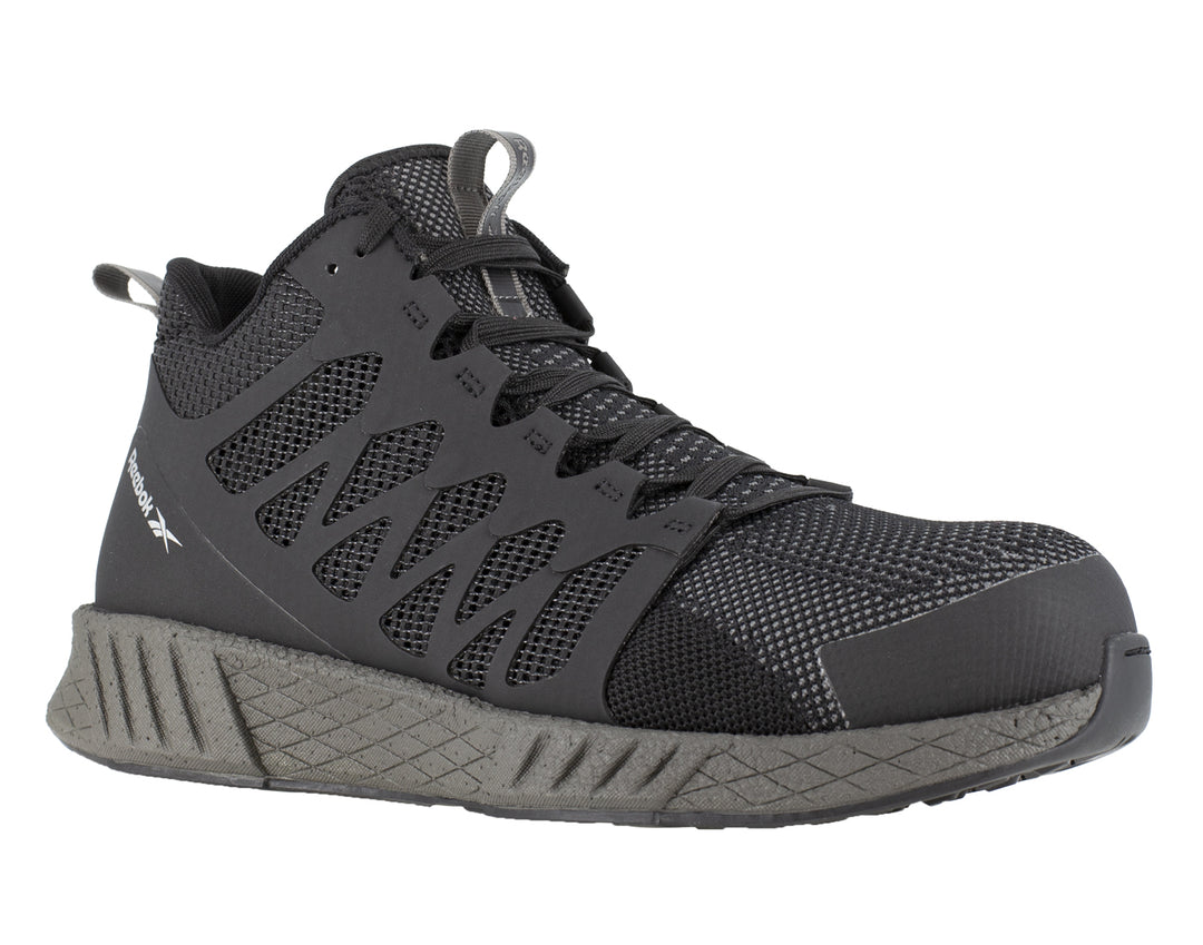 Tenis de seguridad Reebok en color negro con puntera y suela en gris oscuro.