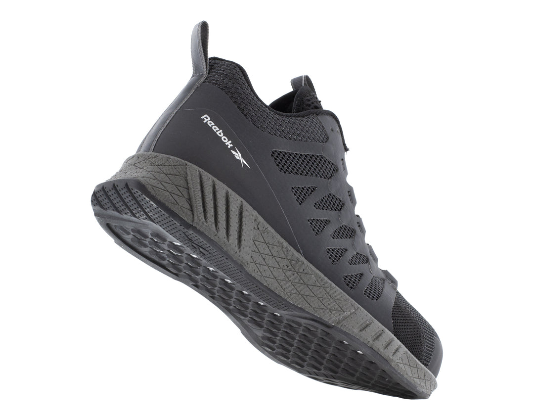 Tenis de seguridad Reebok en color negro con puntera y suela en gris oscuro.