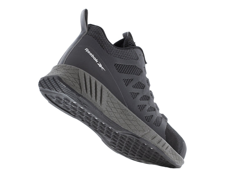 Tenis de seguridad Reebok en color negro con puntera y suela en gris oscuro.