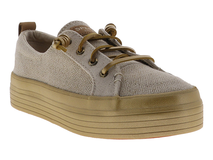Tenis SPERRY de plataforma color dorado con acabado tejido y suela alta brillante.