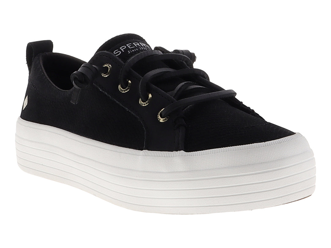 Tenis SPERRY negros con suela de plataforma blanca y cordones negros.