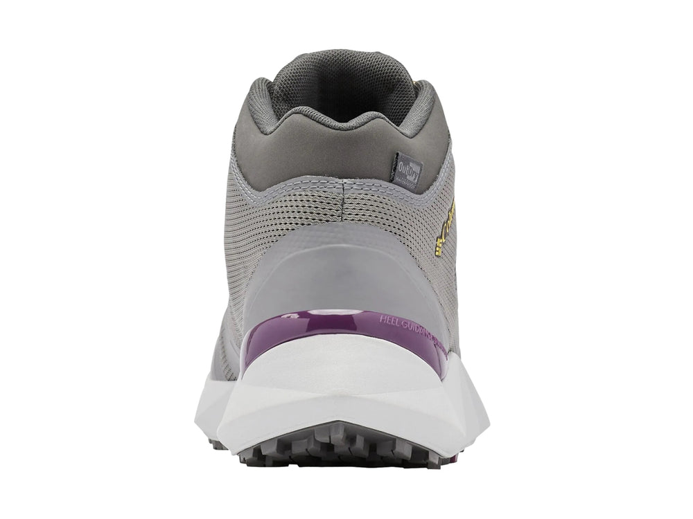 Zapato de senderismo Columbia color gris oscuro con detalles en amarillo y suela blanca.