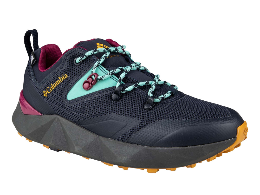 Tenis deportivos Columbia color azul marino con detalles en dorado, turquesa y magenta.