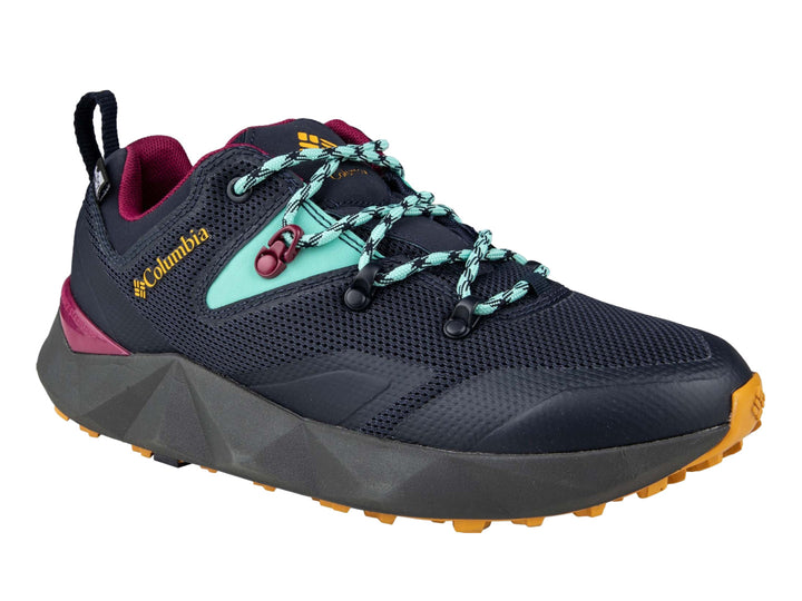 Tenis deportivos Columbia color azul marino con detalles en dorado, turquesa y magenta.