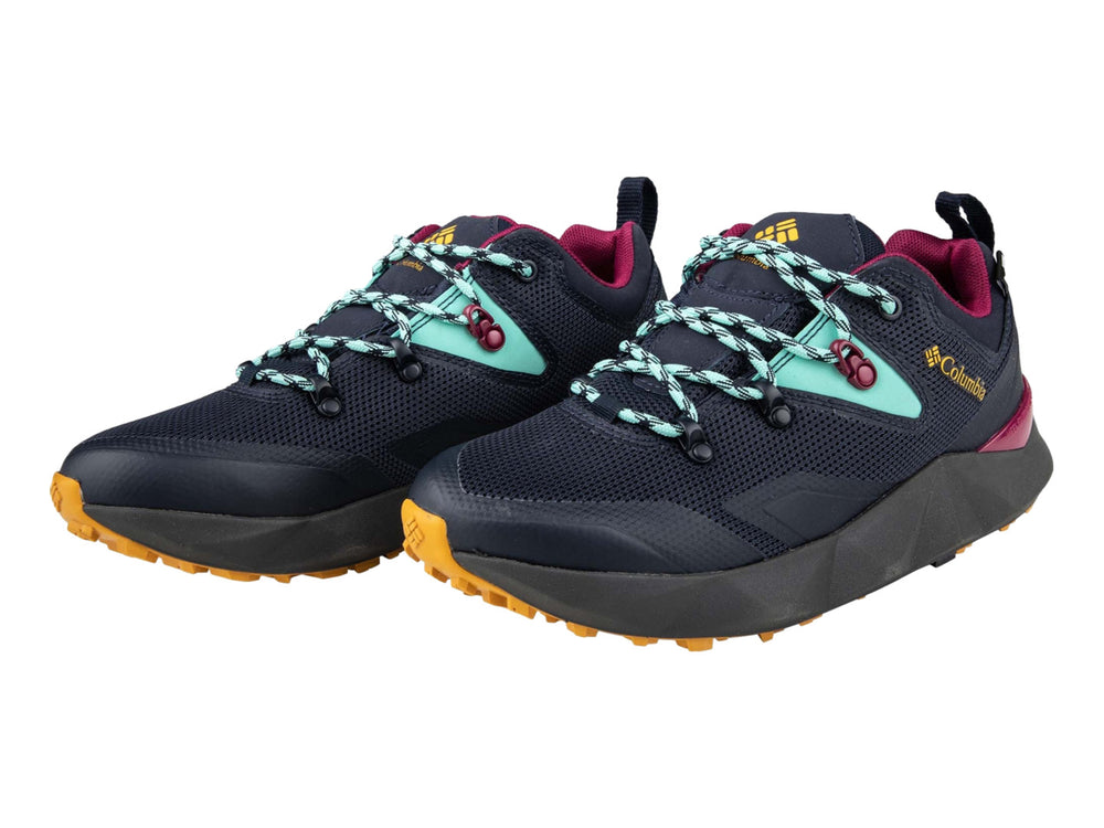 Tenis deportivos Columbia color azul marino con detalles en dorado, turquesa y magenta.
