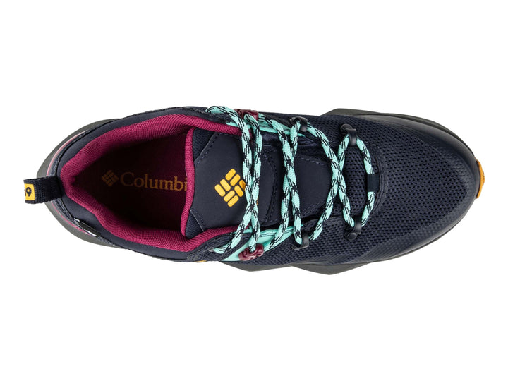 Tenis deportivos Columbia color azul marino con detalles en dorado, turquesa y magenta.
