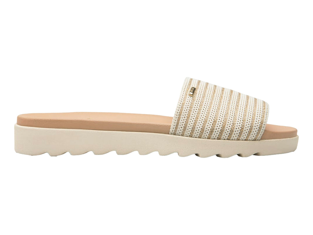 Sandalia Flexi color beige con correa de rayas y suela blanca.