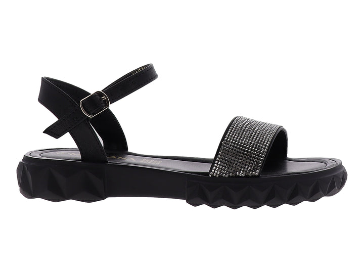 Sandalias negras para niña con plataforma dentada y tira frontal plateada brillante con cierre de hebilla.