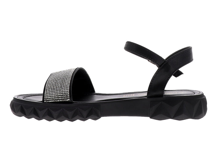 Sandalias negras para niña con plataforma dentada y tira frontal plateada brillante con cierre de hebilla.