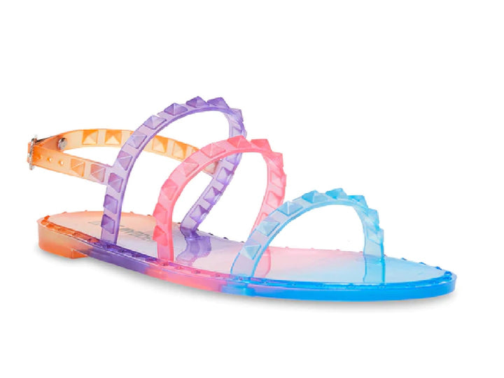 Sandalia plana multicolor con tiras tachonadas y efecto degradado en tonos naranja, morado, rosa y azul.
