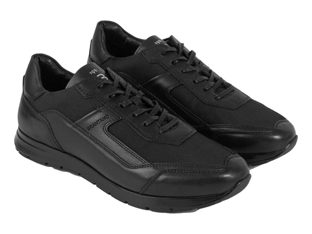 Calzado casual Brantano en color negro, confeccionado en piel y tela con suela a juego.