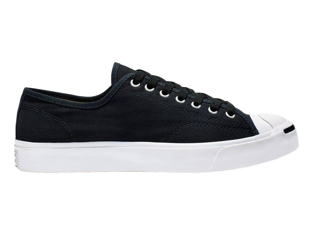 Tenis Converse Jack Purcell de color negro con suela y punta blanca, vista lateral.