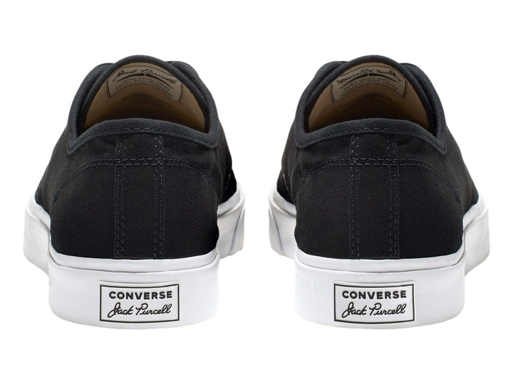 Tenis Converse Jack Purcell de color negro con suela y punta blanca, vista lateral.