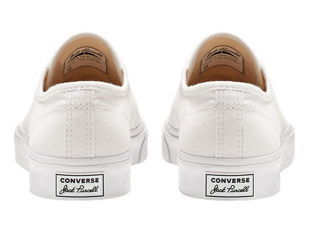 Tenis Converse Jack Purcell blancos de lona con suela blanca y punta redondeada.