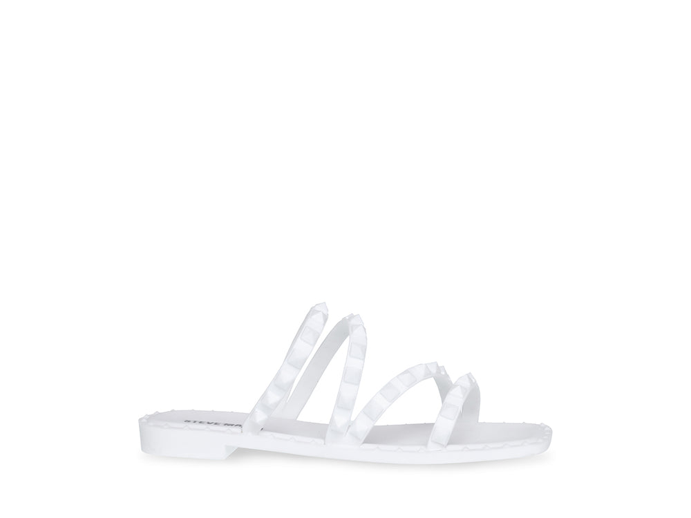 Sandalia blanca de Steve Madden con correas frontales decoradas con bordes dentados y suela plana.