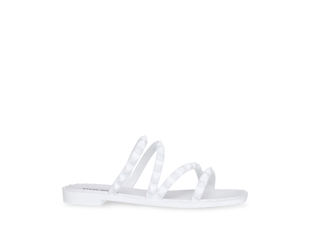 Sandalia blanca de Steve Madden con correas frontales decoradas con bordes dentados y suela plana.