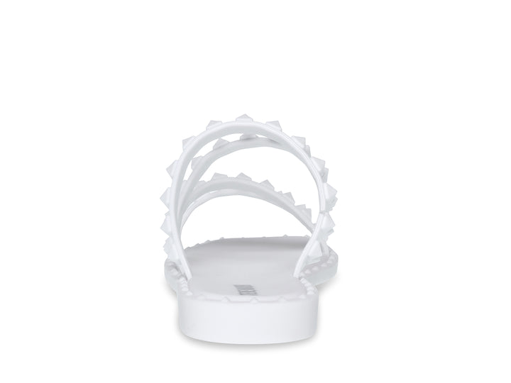 Sandalia blanca de Steve Madden con correas frontales decoradas con bordes dentados y suela plana.