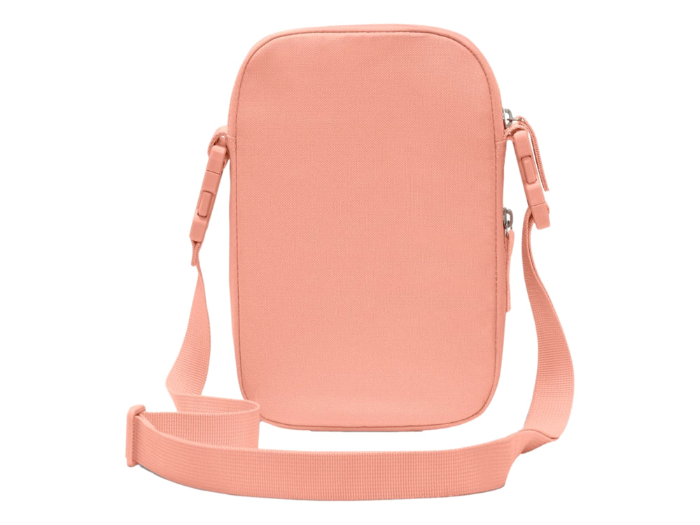 Bolso bandolera Nike Heritage en color salmón con logotipo blanco y correa ajustable.