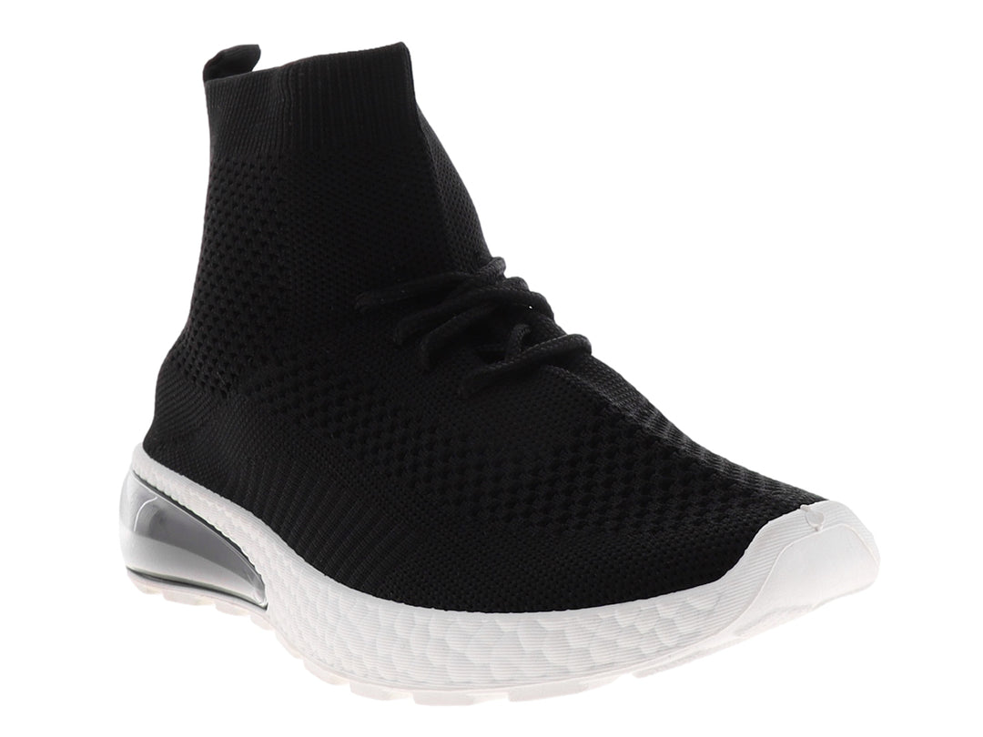 Tenis deportivos negros estilo calcetín con suela blanca y cámara de aire en el talón.