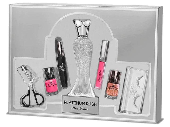 Set de belleza Paris Hilton Platinum Rush con perfume, maquillaje y accesorios en estuche plateado.
