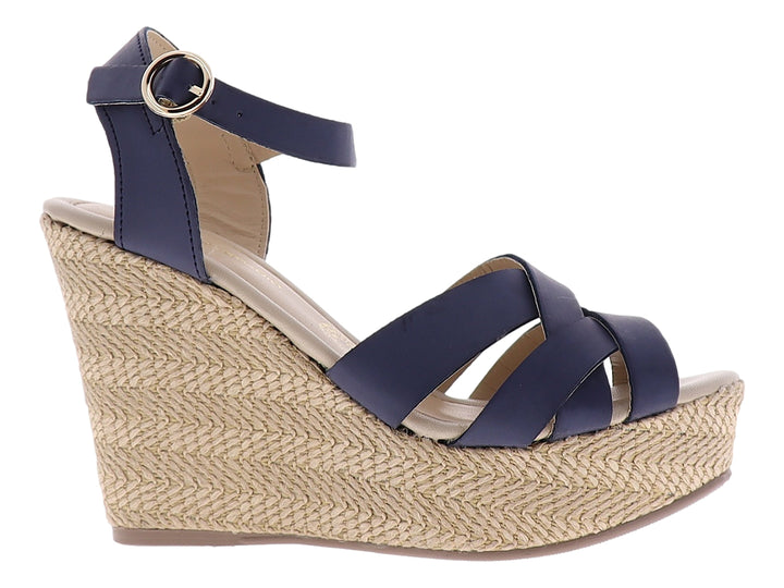 Sandalia de plataforma cuña con tiras cruzadas azul marino y base de yute beige.