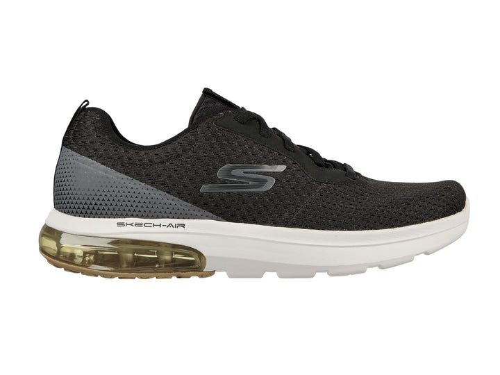Tenis deportivos Skechers color negro con suela blanca y amortiguación amarilla en el talón.