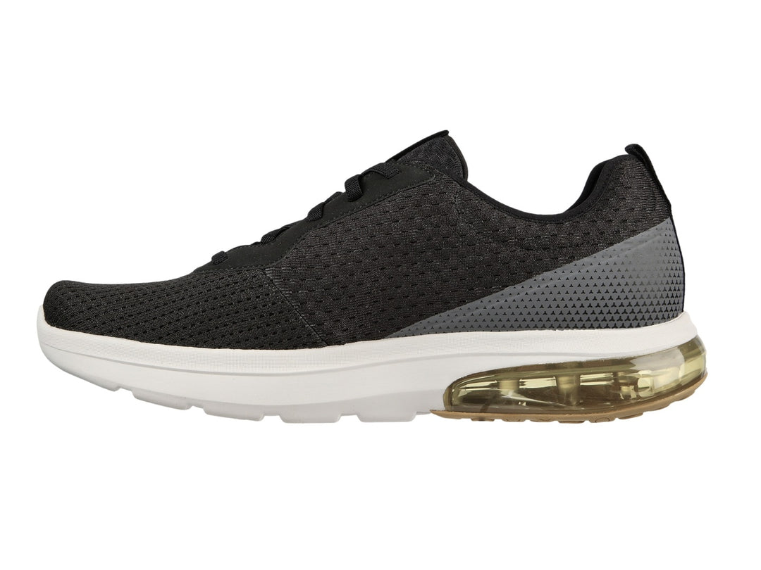 Tenis deportivos Skechers color negro con suela blanca y amortiguación amarilla en el talón.