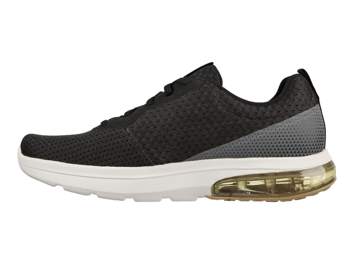 Tenis deportivos Skechers color negro con suela blanca y amortiguación amarilla en el talón.