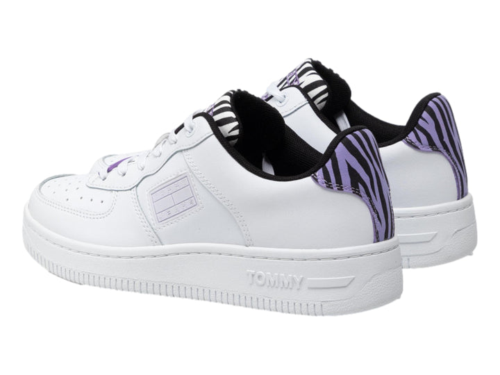 Tenis Tommy Hilfiger color blanco con detalles en estampado de cebra morado y negro en el talón y lengüeta.